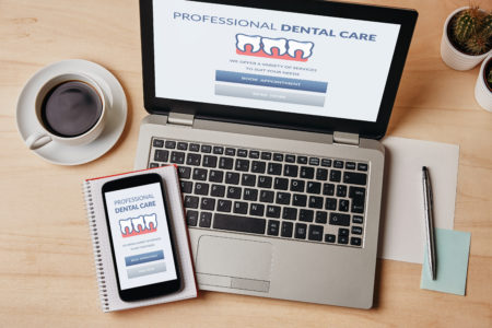 Smartphone and laptop set up and ready for teledentistry