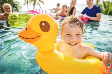 Boy in innertube smiles after visiting Rocky Hill family dentist