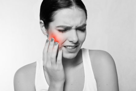 a patient in pain who needs an emergency dentist