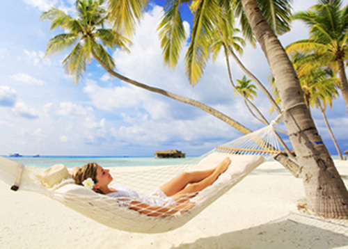 Young woman resting in a hammock portraying how sedation dentistry helps you relax