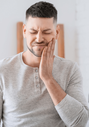 Man holding the side of his face